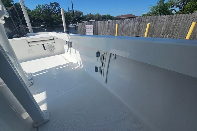 Slide: The Image of 2017 Sea Hunt BX 22 BR boat interior with clean white deck and storage compartments. - 23