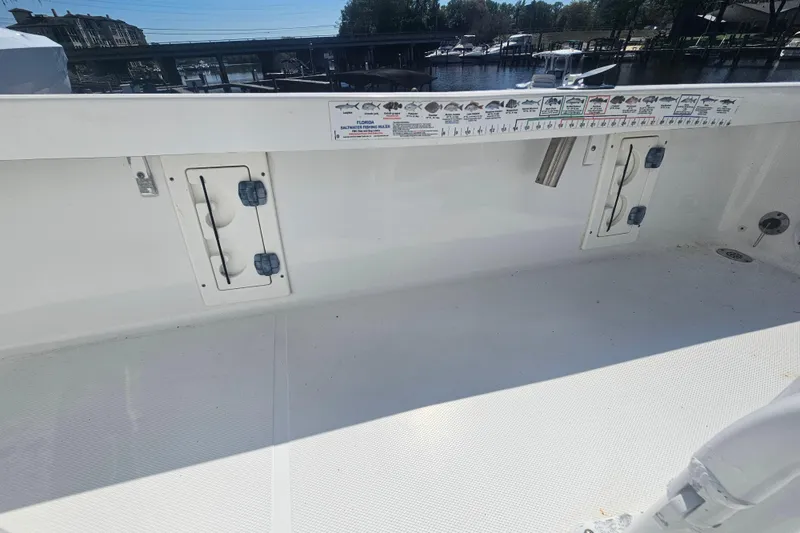 Slide: The Image of 2017 Sea Hunt BX 22 BR boat interior with fishing rod holders and storage compartments. - 24