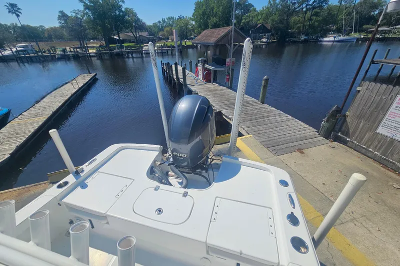 Slide: The Image of 2017 Sea Hunt BX 22 BR boat docked by a serene waterfront. - 25