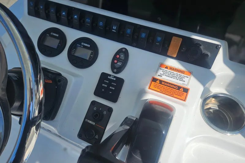 Slide: The Image of Control panel of a 2017 Sea Hunt BX 22 BR boat with Yamaha gauges and warning labels. - 27