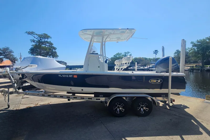 Slide: The Image of 2017 Sea Hunt BX 22 BR boat on trailer by waterfront, sunny day. - 5