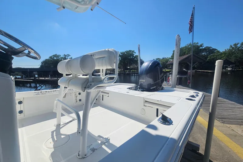 Slide: The Image of 2017 Sea Hunt BX 22 BR boat docked, featuring a powerful outboard motor and sleek design. - 7
