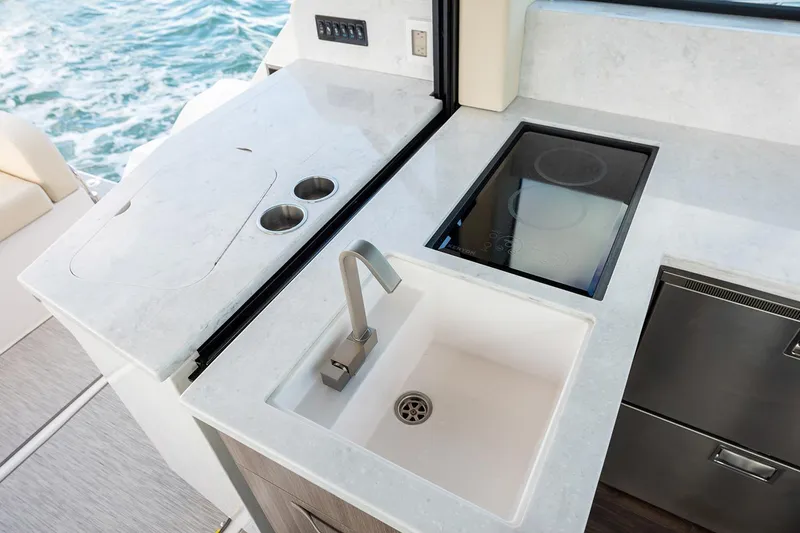 Slide: The Image of Manufacturer Provided Image: Modern kitchen area on 2026 Regal 38 FXO yacht with sink and stove. - 14