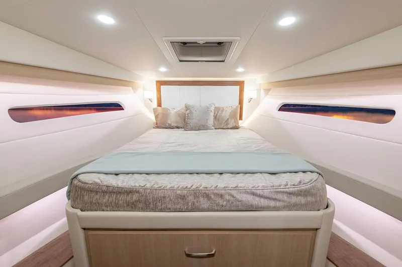 Slide: The Image of Manufacturer Provided Image: Luxurious cabin interior of 2026 Regal 38 FXO yacht with elegant bedding and ambient lighting. - 20