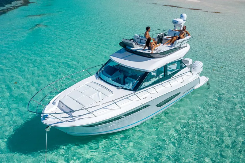 Slide: The Image of Manufacturer Provided Image: 2026 Regal 38 FXO yacht on clear turquoise water, with people relaxing on deck. - 3