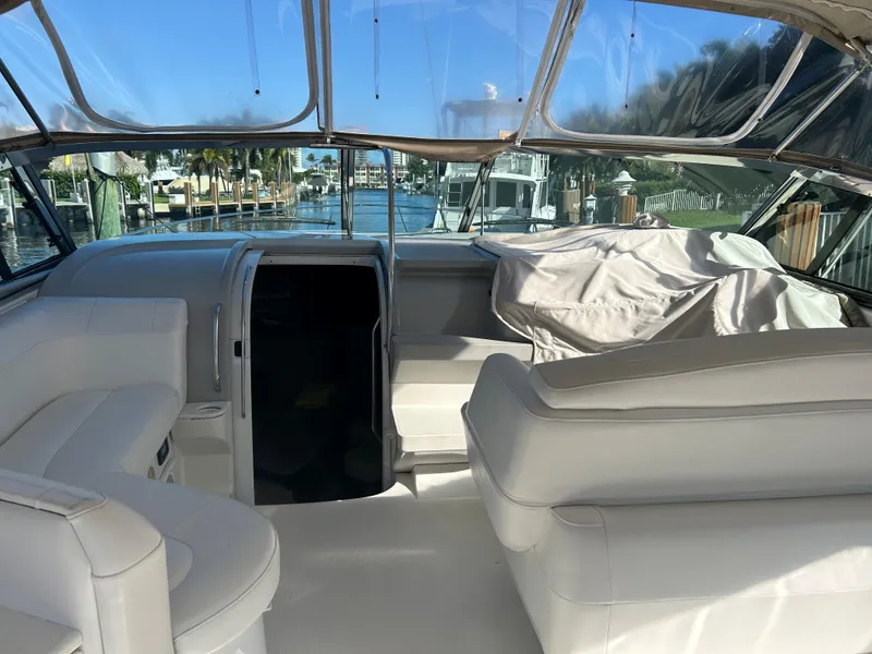 Slide: The Image of 2001 Formula 41 PC yacht interior with white seating and marina view. - 10