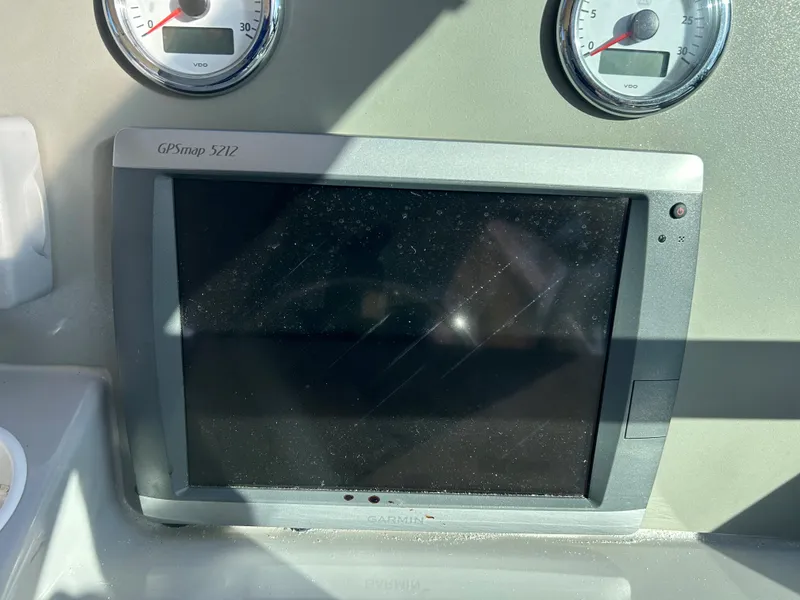 Slide: The Image of GPS display and gauges on a 2001 Formula 41 PC boat dashboard. - 23