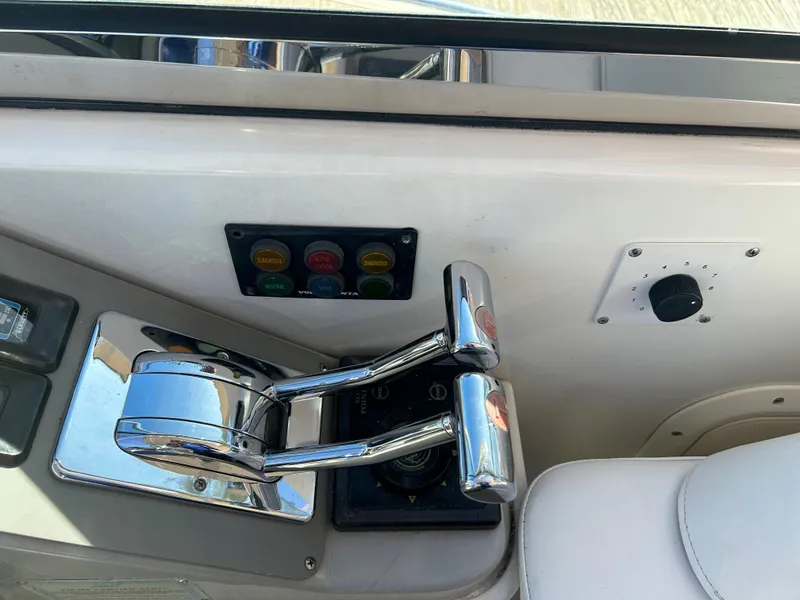 Slide: The Image of Control panel of a 2001 Formula 41 PC boat with chrome levers and buttons. - 25