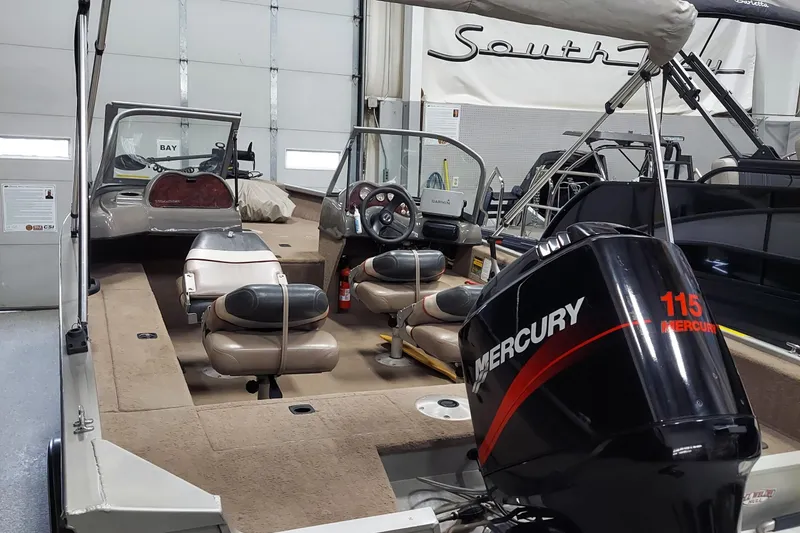 Slide: The Image of 2006 Tracker Pro Guide V-175 WT boat with Mercury 115 engine in showroom. - 3