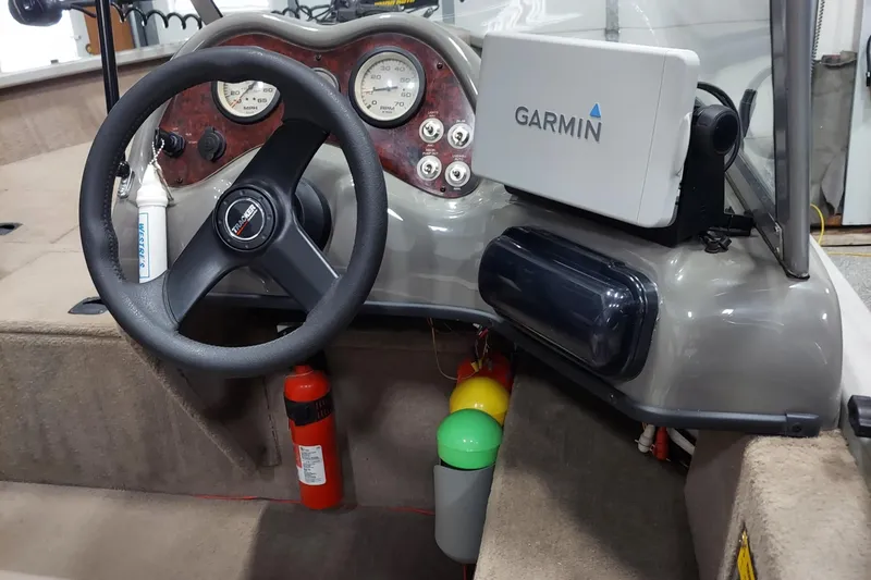 Slide: The Image of 2006 Tracker Pro Guide V-175 WT boat dashboard with Garmin GPS and steering wheel. - 4