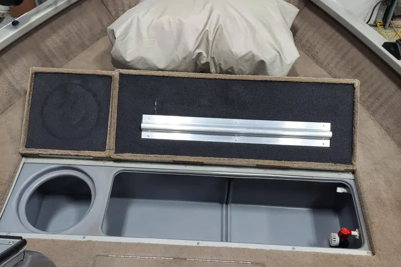 Slide: The Image of 2006 Tracker Pro Guide V-175 WT boat interior storage compartment with cup holder and latch. - 5