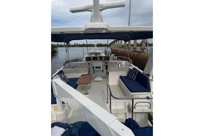 Slide: The Image of 2010 DeFever 48 Trawler kitchen with stainless steel fridge and wooden cabinetry. - 13