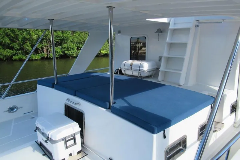 Slide: The Image of Wooden staircase with built-in wine storage on a 2010 DeFever 48 Trawler yacht. - 14