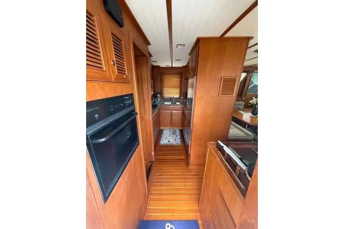 Slide: The Image of Pilothouse interior of 2010 DeFever 48 Trawler with wooden steering wheel and navigation equipment. - 4
