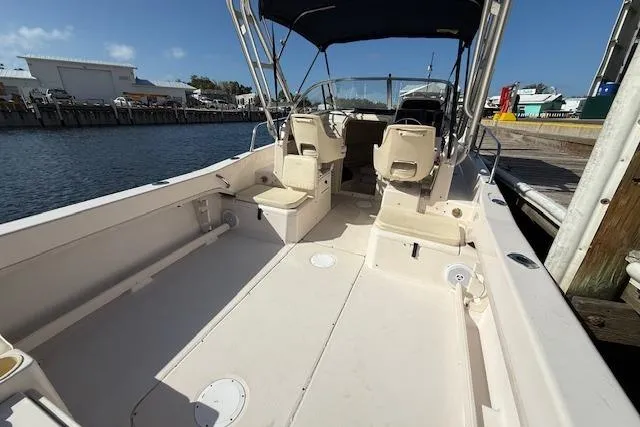 Slide: The Image of 2000 Grady-White Seafarer 22 boat with spacious deck and seating, docked by the water. - 13