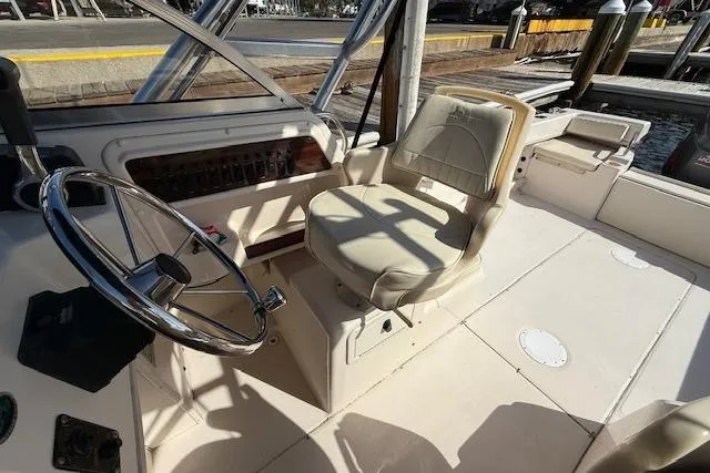 Slide: The Image of Interior of 2000 Grady-White Seafarer 22 boat with steering wheel and captain's chair. - 16