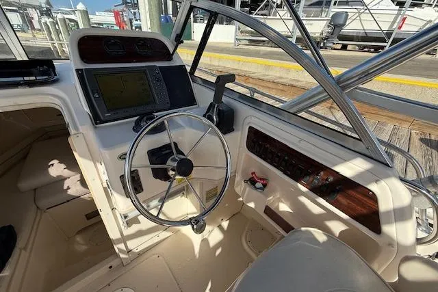 Slide: The Image of Cockpit of 2000 Grady-White Seafarer 22 boat with steering wheel and navigation equipment. - 17