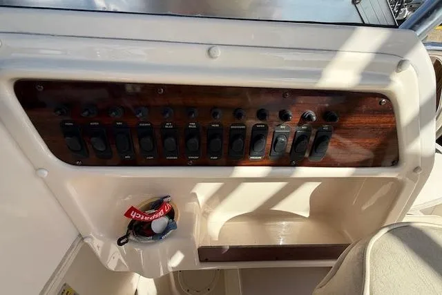 Slide: The Image of Control panel of a 2000 Grady-White Seafarer 22 boat with switches and key. - 20