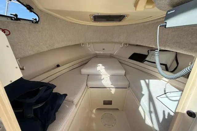 Slide: The Image of Interior cabin of 2000 Grady-White Seafarer 22 boat, featuring cozy seating and storage. - 21