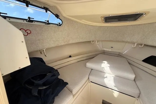 Slide: The Image of Interior cabin of 2000 Grady-White Seafarer 22 boat, featuring cushioned seating and storage. - 22