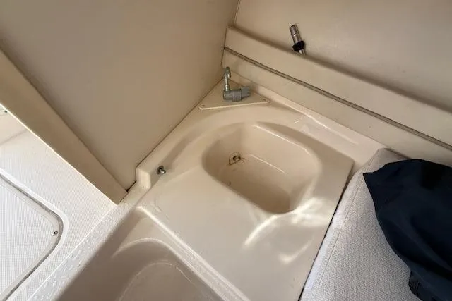 Slide: The Image of Interior view of a 2000 Grady-White Seafarer 22 boat, featuring a storage compartment. - 25