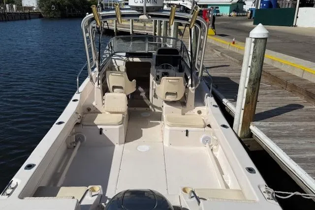 Slide: The Image of 2000 Grady-White Seafarer 22 boat docked, showcasing spacious deck and seating. - 5