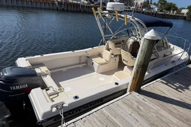 Slide: The Image of 2000 Grady-White Seafarer 22 boat docked, featuring Yamaha outboard motor and spacious deck. - 6