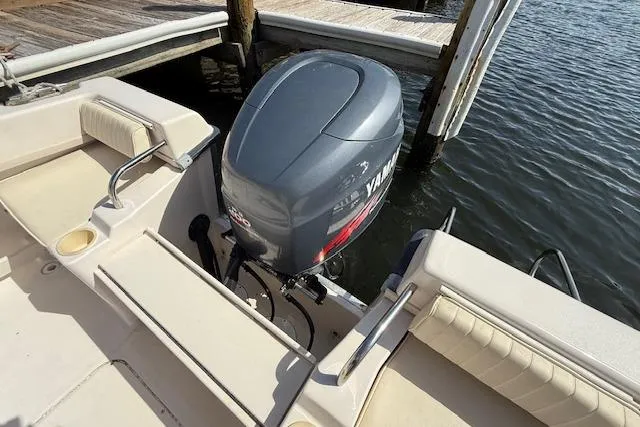 Slide: The Image of Grady-White Seafarer 22 boat with Yamaha outboard motor, docked by the water. - 9