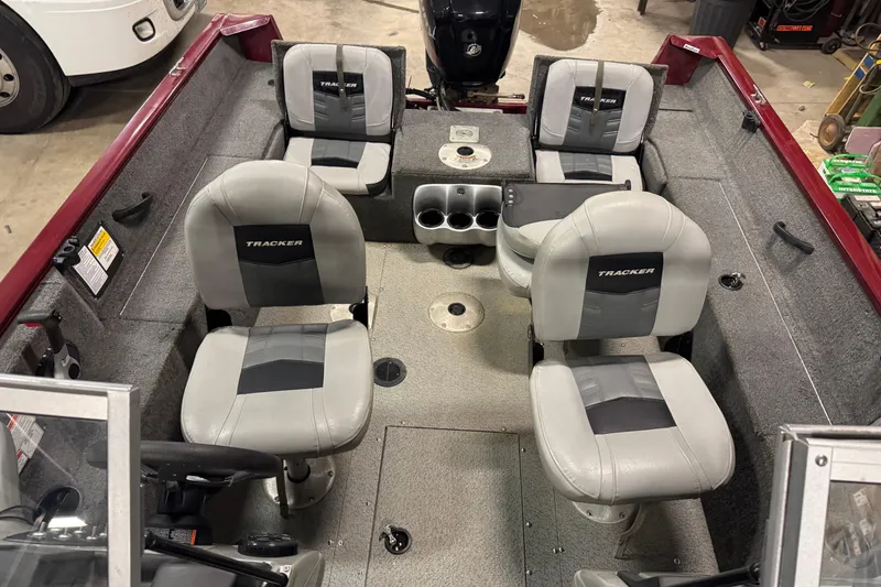 Slide: The Image of 2017 Tracker Pro Guide V-175 Combo boat interior with four gray seats and cup holders. - 12