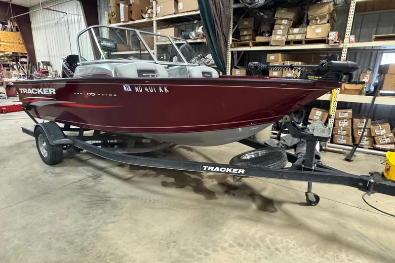 Slide: The Image of 2017 Tracker Pro Guide V-175 Combo boat on trailer in warehouse setting. - 2