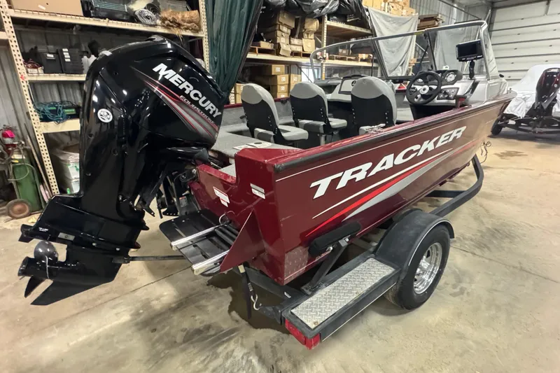 Slide: The Image of 2017 Tracker Pro Guide V-175 Combo boat with Mercury engine in a garage. - 3