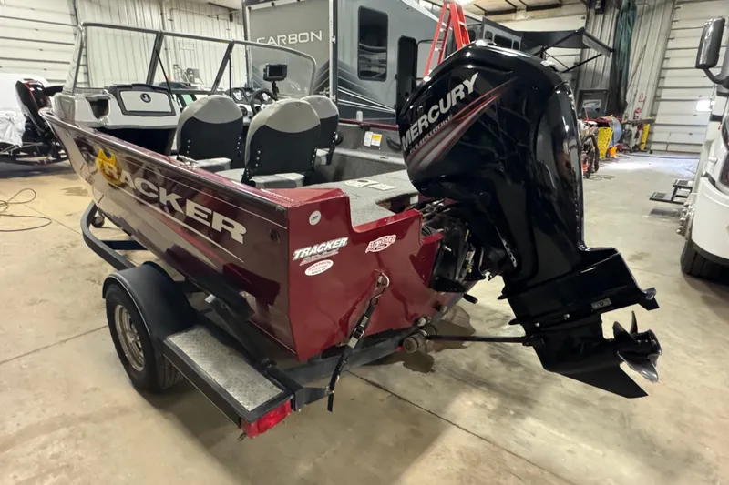Slide: The Image of 2017 Tracker Pro Guide V-175 Combo boat with Mercury outboard motor in a garage. - 4