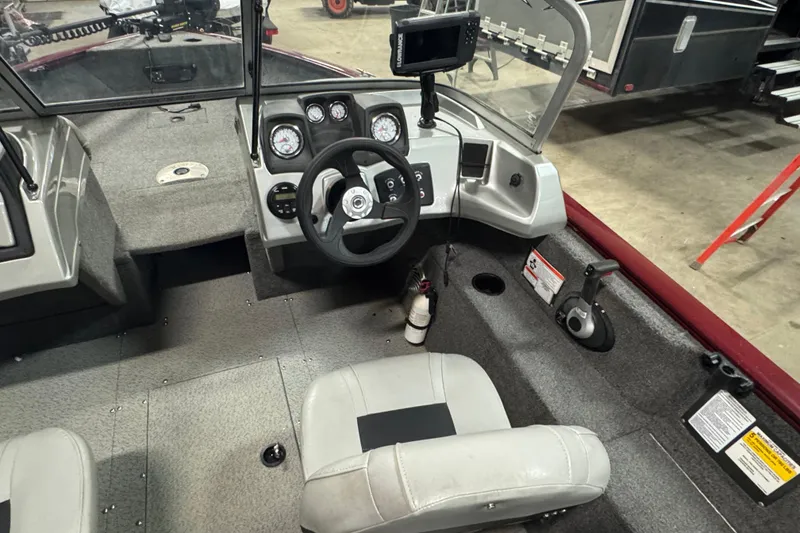 Slide: The Image of 2017 Tracker Pro Guide V-175 Combo boat interior with steering wheel and dashboard controls. - 5