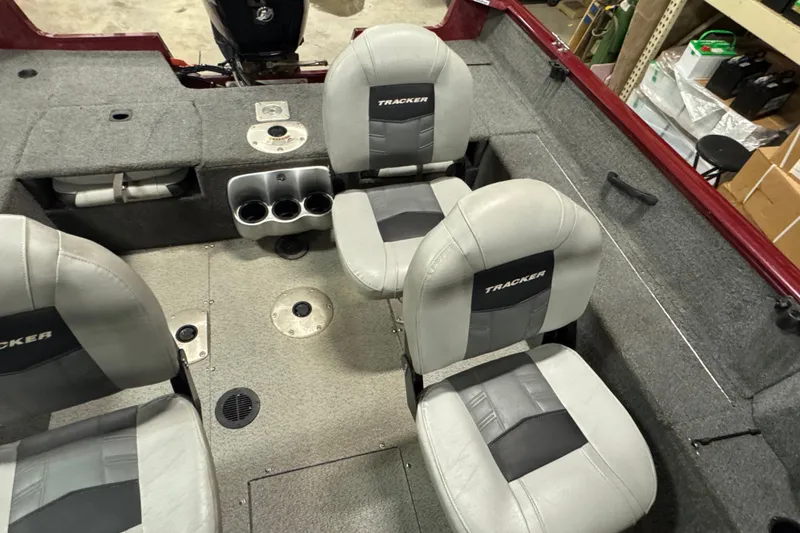 Slide: The Image of 2017 Tracker Pro Guide V-175 Combo boat interior with gray seating and cup holders. - 7