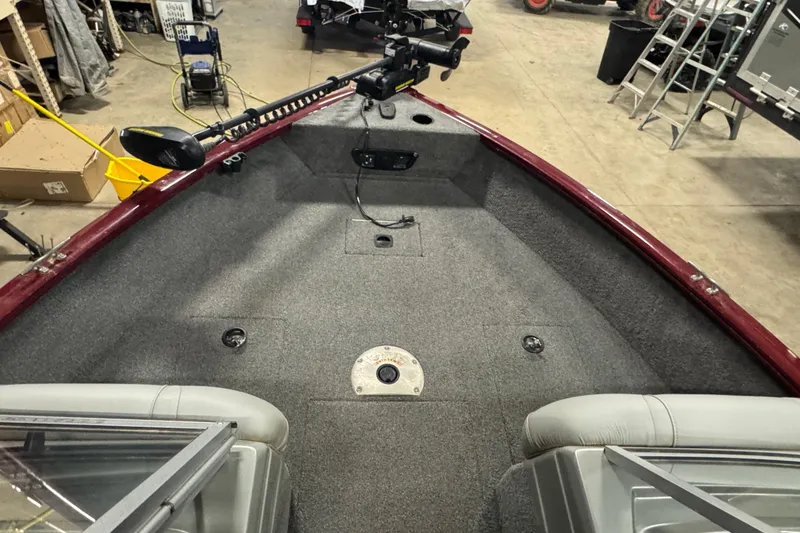 Slide: The Image of 2017 Tracker Pro Guide V-175 Combo boat interior with trolling motor in a garage setting. - 9