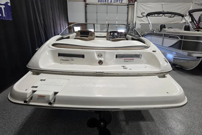 Slide: The Image of Rear view of a 2007 Mariah SX19 boat in a showroom setting. - 4
