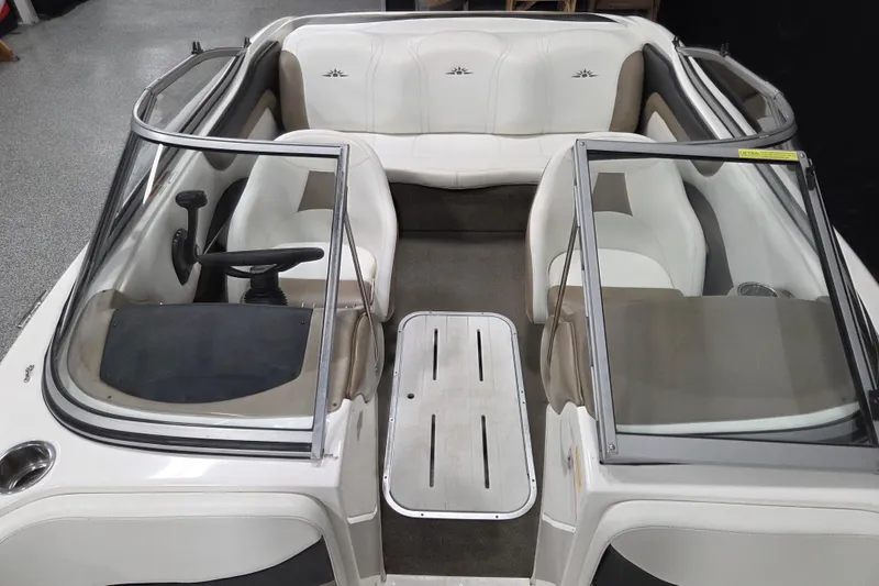 Slide: The Image of Interior of a 2007 Mariah SX19 boat with white seating and dual consoles. - 7