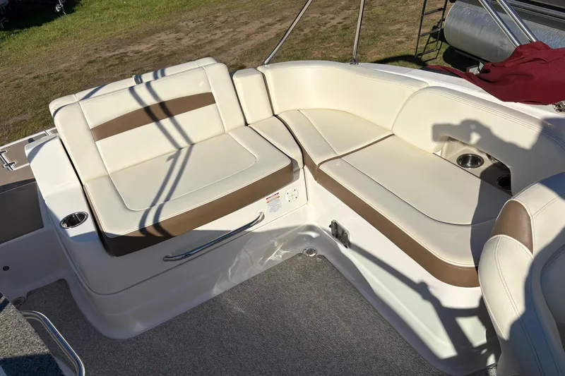 Slide: The Image of 2013 Chaparral 244 Sunesta boat interior with beige and brown seating. - 10