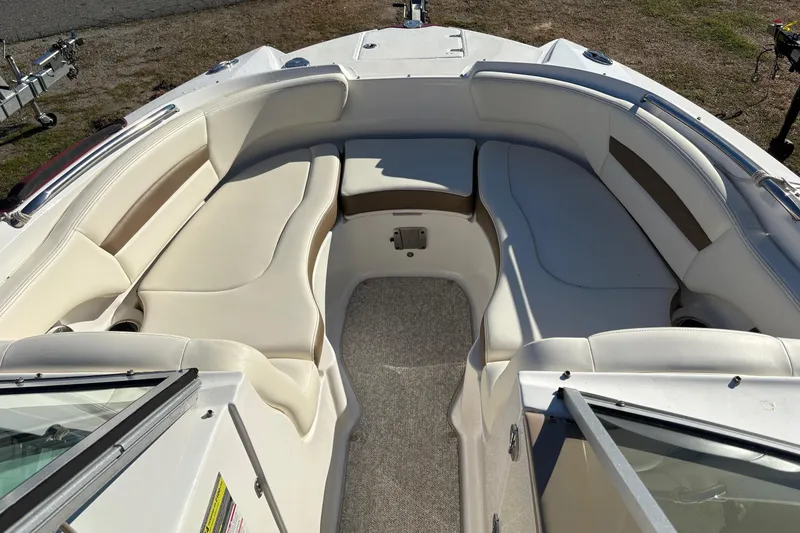 Slide: The Image of 2013 Chaparral 244 Sunesta boat interior with spacious seating and beige upholstery. - 4