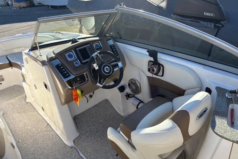 Slide: The Image of Interior view of 2013 Chaparral 244 Sunesta boat cockpit with steering wheel and controls. - 6