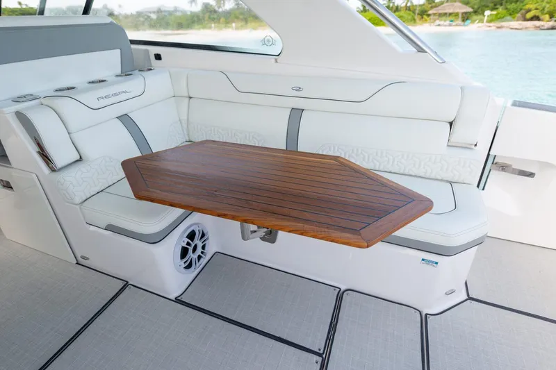 Slide: The Image of Manufacturer Provided Image: Luxurious interior of 2026 Regal LX36 boat with elegant seating and wooden table. - 10