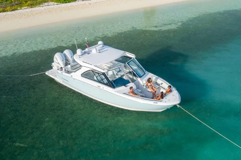 Slide: The Image of Manufacturer Provided Image: 2026 Regal LX36 boat anchored in clear turquoise water near a sandy beach. - 3