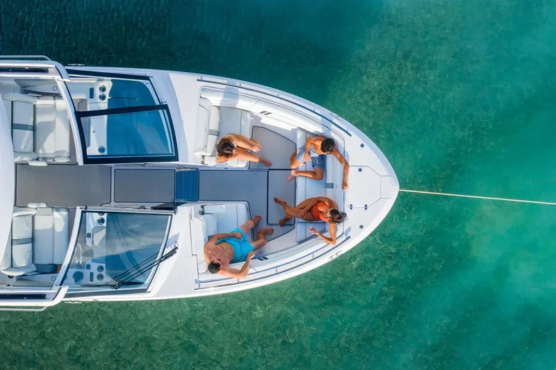 Slide: The Image of Manufacturer Provided Image: Aerial view of 2026 Regal LX36 boat with people relaxing on deck in clear water. - 4