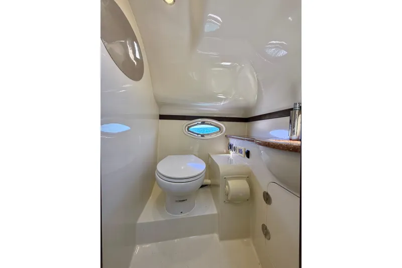 Slide: The Image of Luxurious 2012 Hunton XRS 37 yacht bathroom with modern fixtures and porthole window. - 19