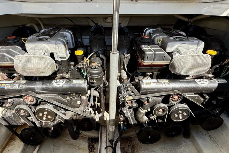 Slide: The Image of Twin engines of a 2012 Hunton XRS 37 boat, showcasing mechanical components. - 21