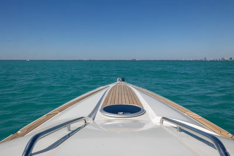 Slide: The Image of Bow view of 2012 Hunton XRS 37 yacht cruising on clear blue waters. - 3