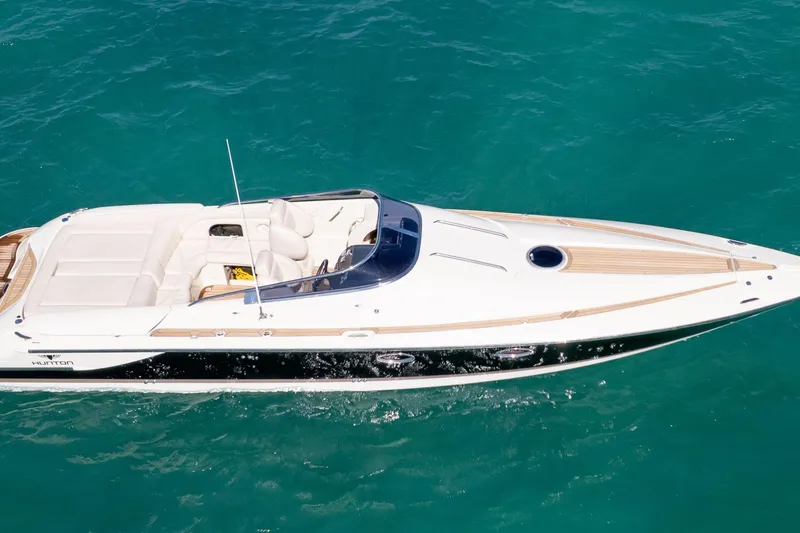 Slide: The Image of 2012 Hunton XRS 37 luxury speedboat cruising on clear turquoise water. - 5