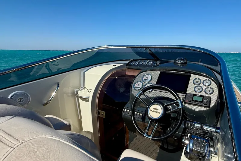 Slide: The Image of Cockpit of 2012 Hunton XRS 37 boat with steering wheel and dashboard controls. - 6