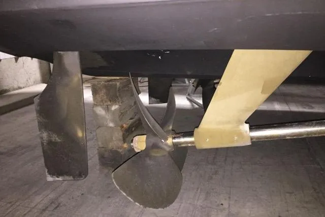 Slide: The Image of Propeller and rudder of a 2004 Carver 420 Mariner boat in a dry dock. - 18