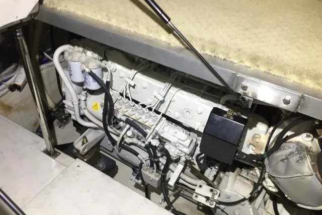 Slide: The Image of Engine compartment of a 2004 Carver 420 Mariner, showcasing mechanical components and wiring. - 21